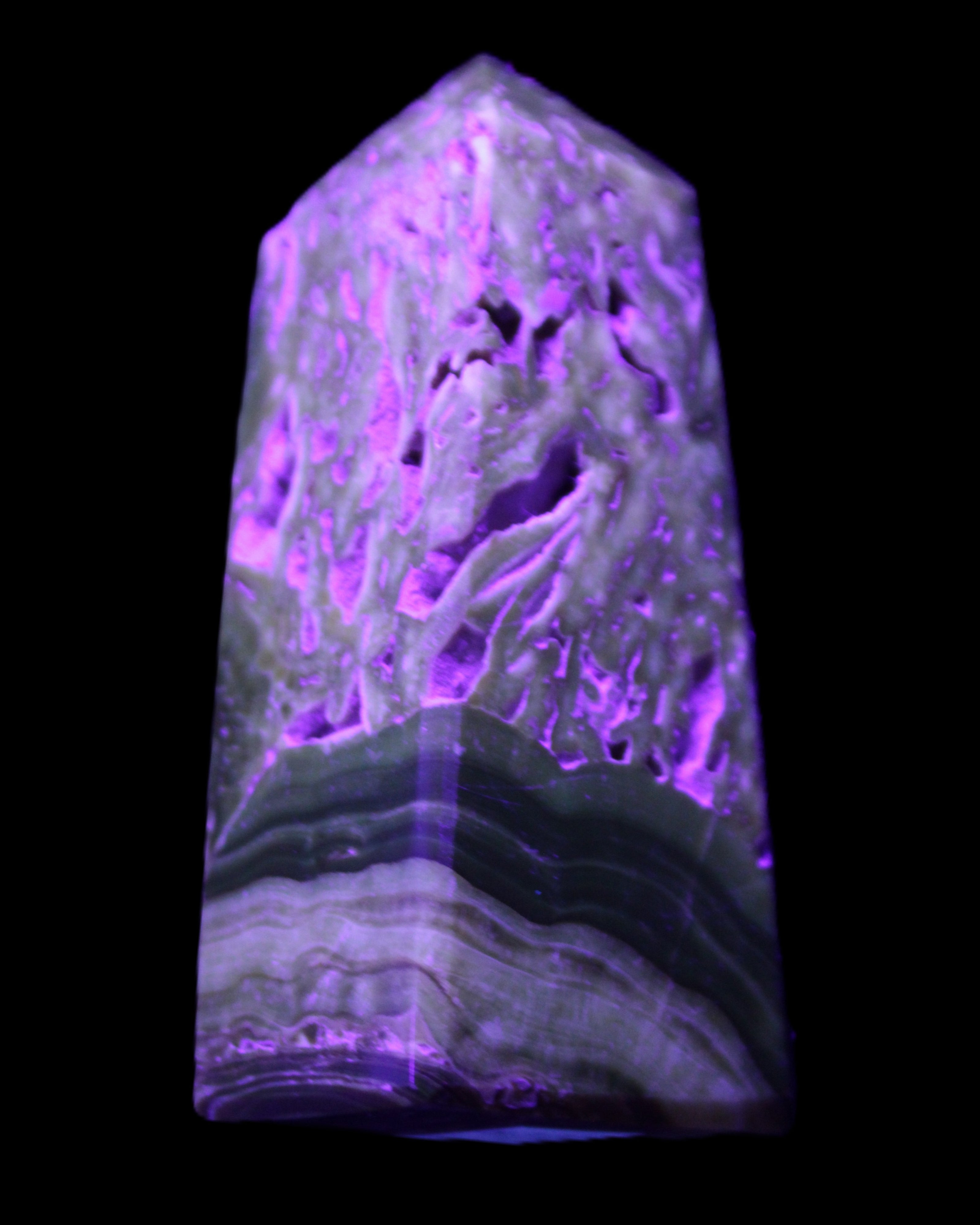 Chocolate Calcite obelisk with caves 95*40mm 217g in UV light - Rocks and Things Store