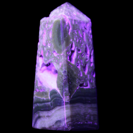 Chocolate Calcite obelisk with caves 95*40mm 217g in UV light - Rocks and Things Store