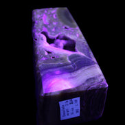 Chocolate Calcite obelisk with caves 95*40mm 217g in UV light - Rocks and Things Store