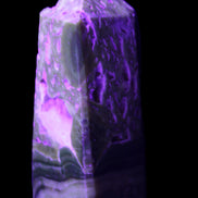 Chocolate Calcite obelisk with caves 95*40mm 217g in UV light - Rocks and Things Store