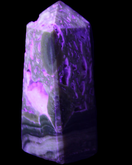 Chocolate Calcite obelisk with caves 95*40mm 217g in UV light - Rocks and Things Store