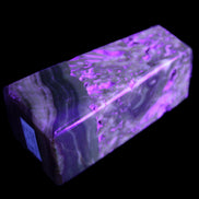 Chocolate Calcite obelisk with caves 95*40mm 217g in UV light - Rocks and Things Store