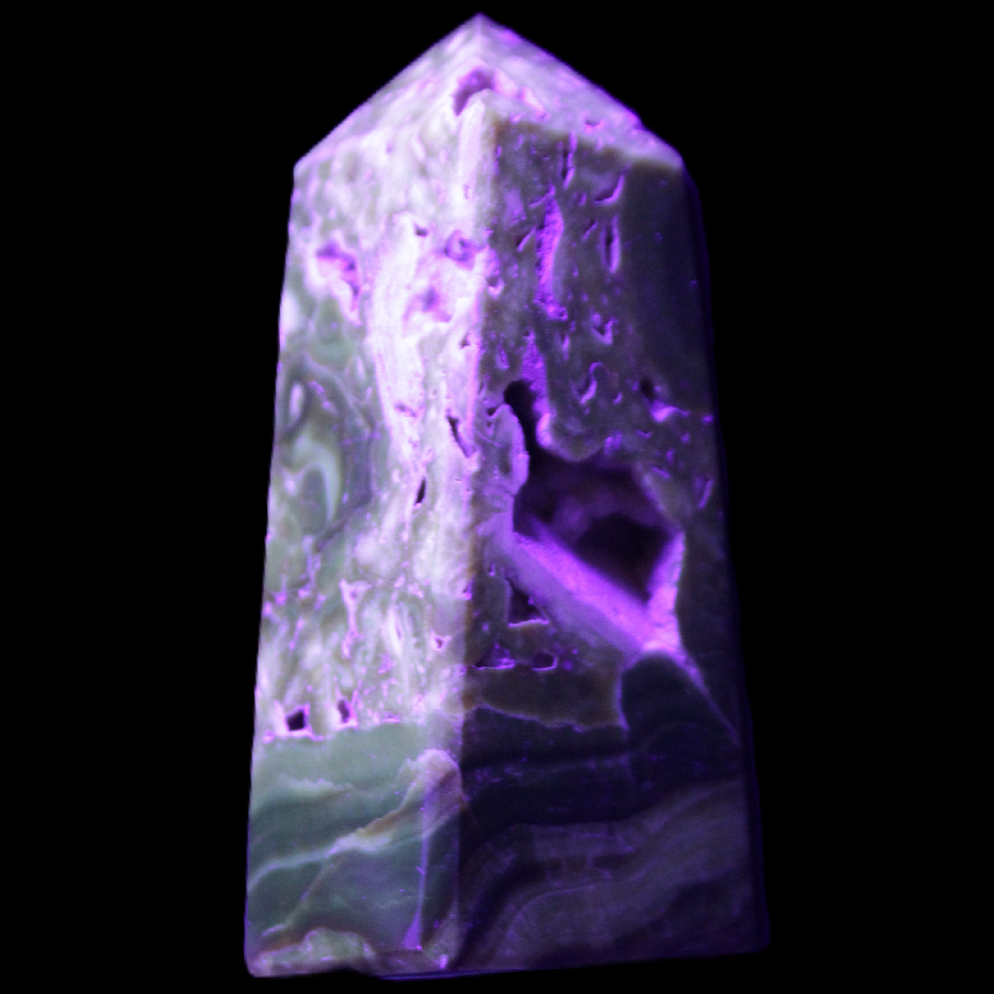 Chocolate Calcite obelisk with caves 95*40mm 217g in UV light - Rocks and Things Store