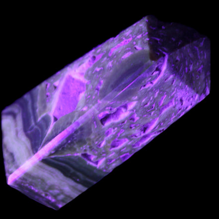 Chocolate Calcite obelisk with caves 95*40mm 217g in UV light - Rocks and Things Store