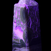 Chocolate Calcite obelisk with caves 95*40mm 217g in UV light - Rocks and Things Store