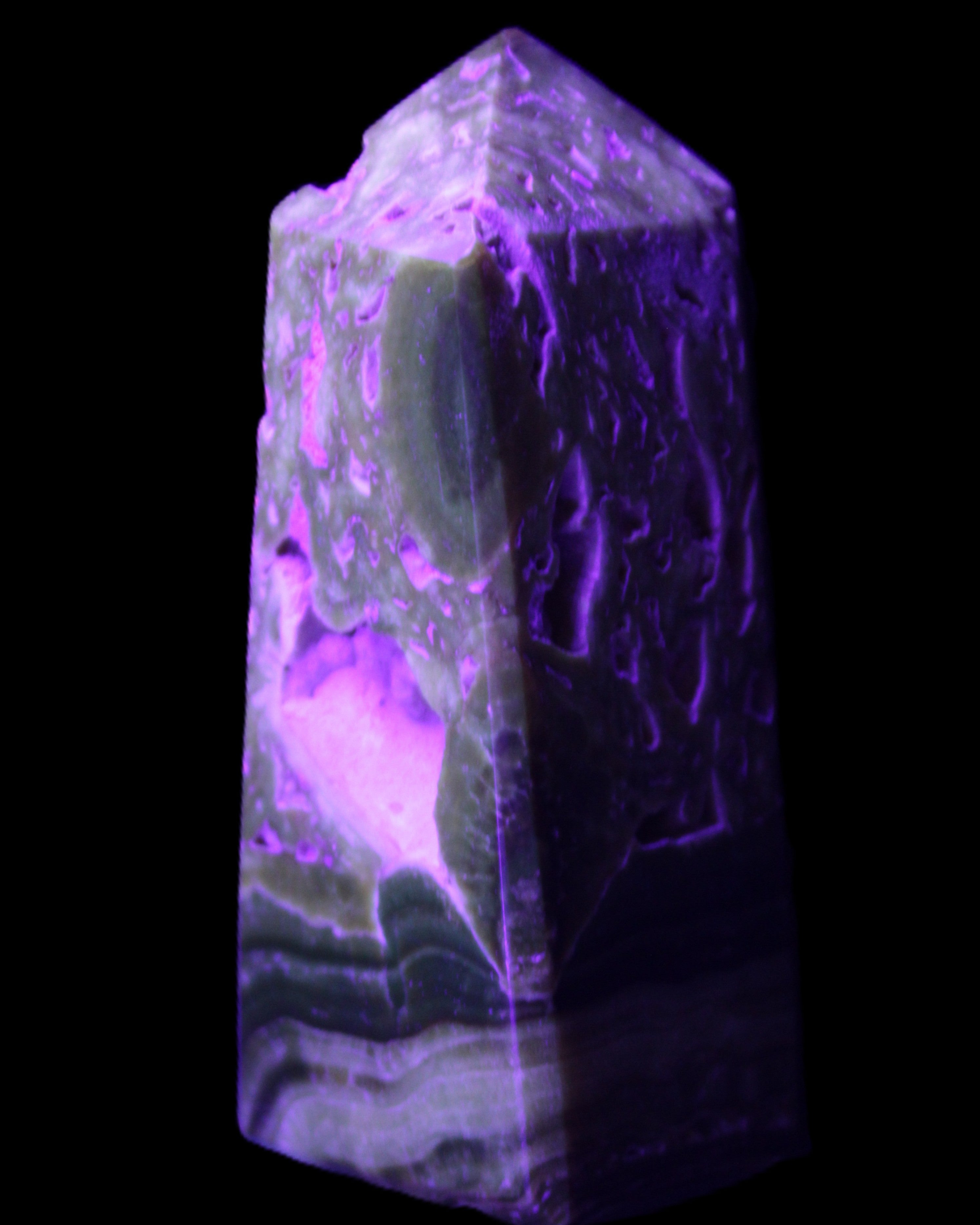 Chocolate Calcite obelisk with caves 95*40mm 217g in UV light - Rocks and Things Store
