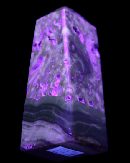 Chocolate Calcite obelisk with caves 95*40mm 217g in UV light - Rocks and Things Store