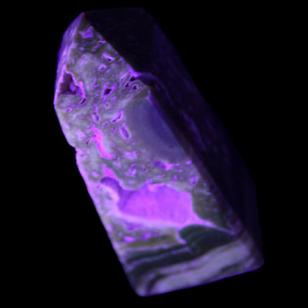 Chocolate Calcite obelisk with caves 95*40mm 217g in UV light - Rocks and Things Store