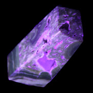 Chocolate Calcite obelisk with caves 95*40mm 217g in UV light - Rocks and Things Store