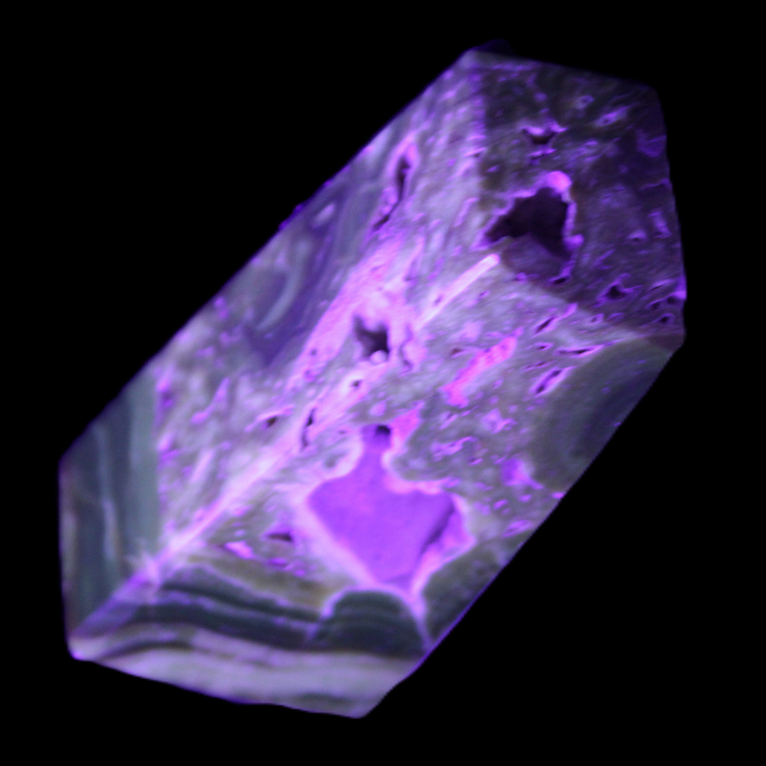 Chocolate Calcite obelisk with caves 95*40mm 217g in UV light - Rocks and Things Store