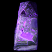 Chocolate Calcite obelisk with caves 95*40mm 217g in UV light - Rocks and Things Store
