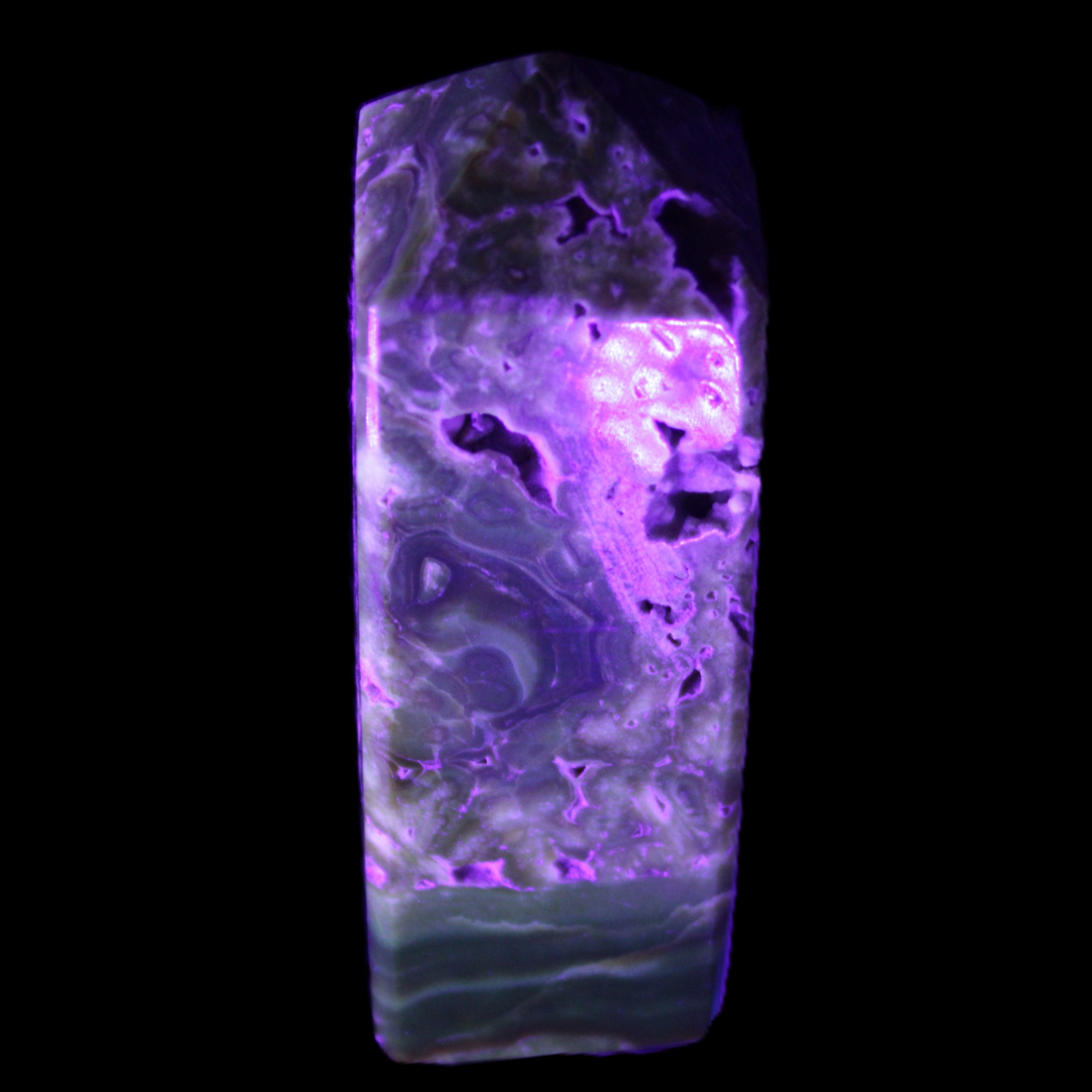 Chocolate Calcite obelisk with caves 95*40mm 217g in UV light - Rocks and Things Store