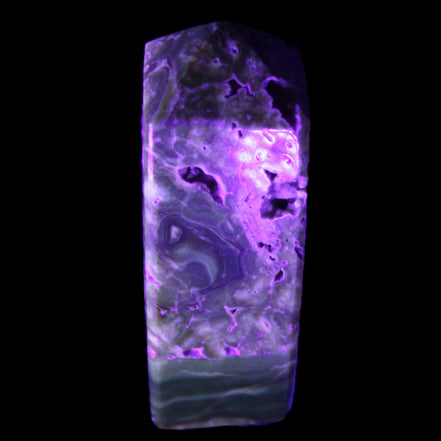 Chocolate Calcite obelisk with caves 95*40mm 217g in UV light - Rocks and Things Store