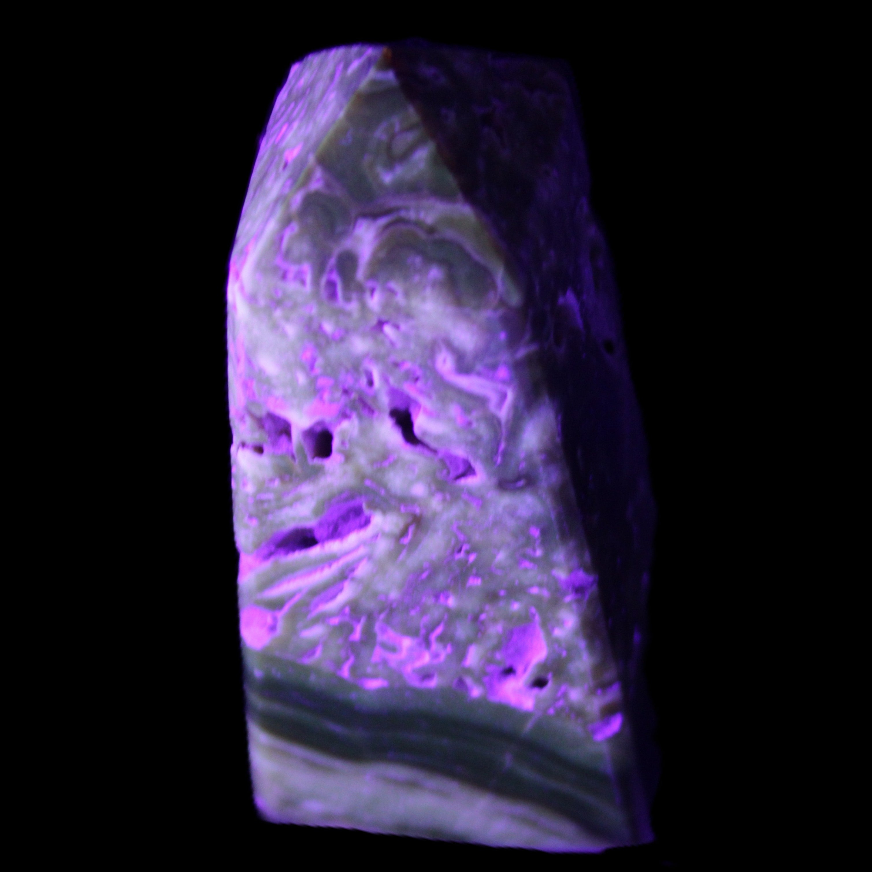 Chocolate Calcite obelisk with caves 95*40mm 217g in UV light - Rocks and Things Store