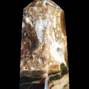Chocolate Calcite obelisk with caves 95*40mm 217g in UV light - Rocks and Things Store