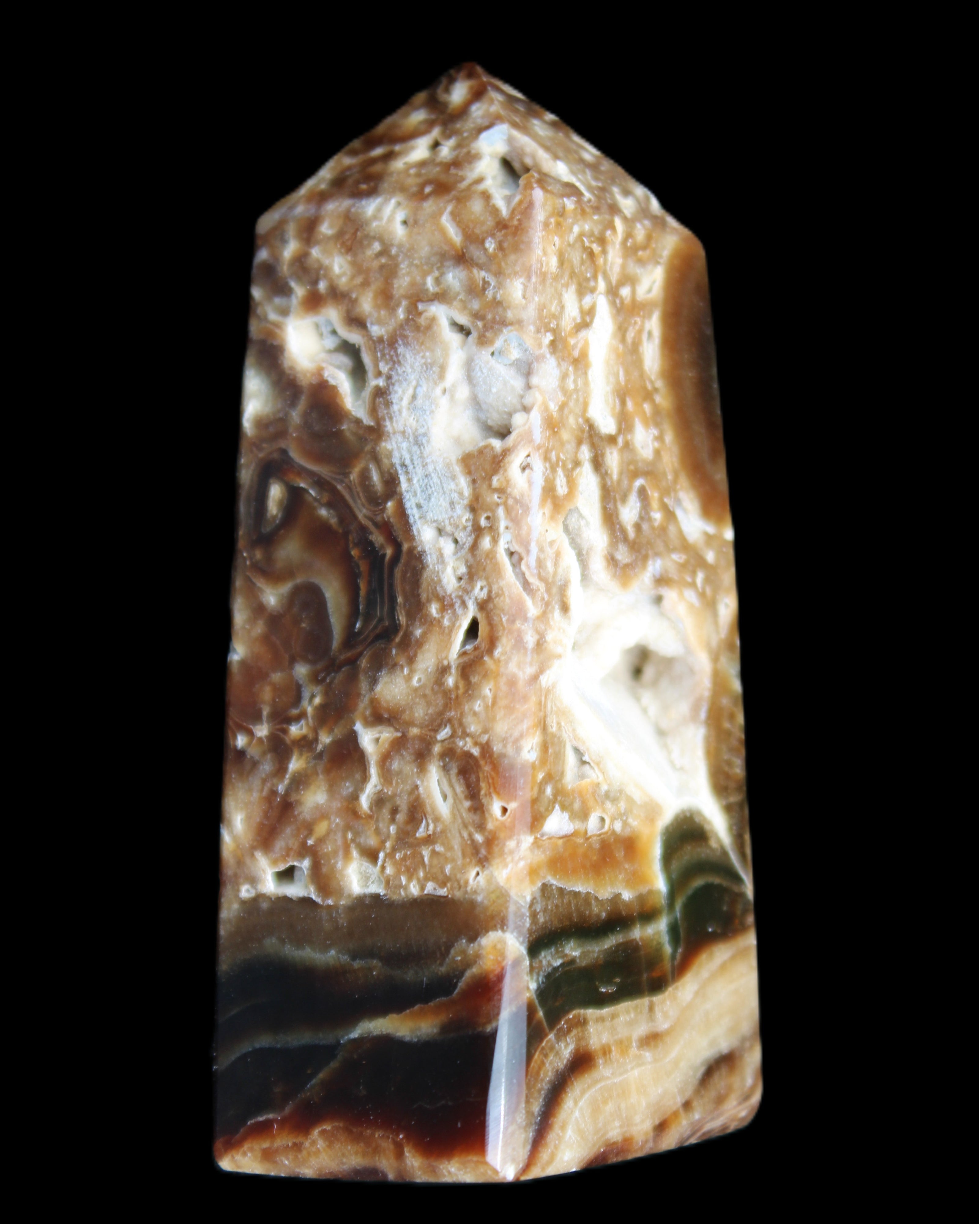 Chocolate Calcite obelisk with caves 95*40mm 217g in UV light - Rocks and Things Store