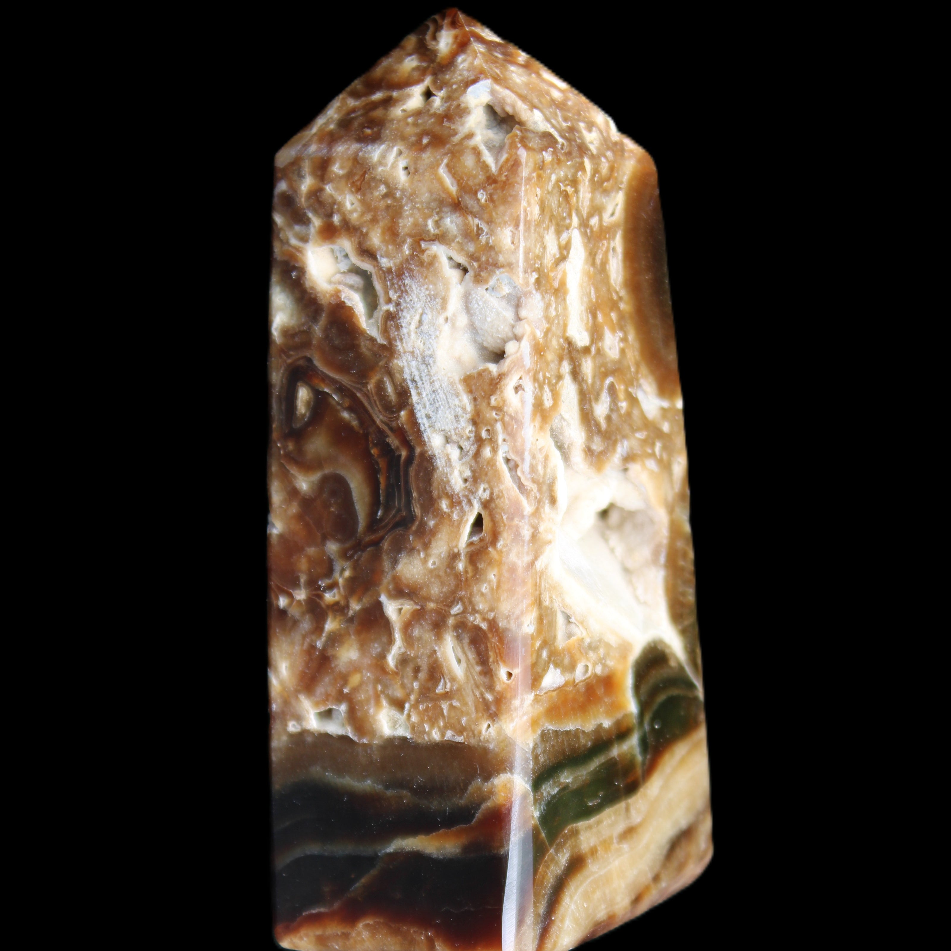 Chocolate Calcite obelisk with caves 95*40mm 217g in UV light - Rocks and Things Store