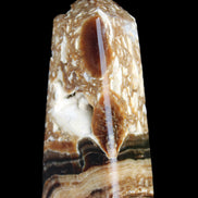 Chocolate Calcite obelisk with caves 95*40mm 217g in UV light - Rocks and Things Store