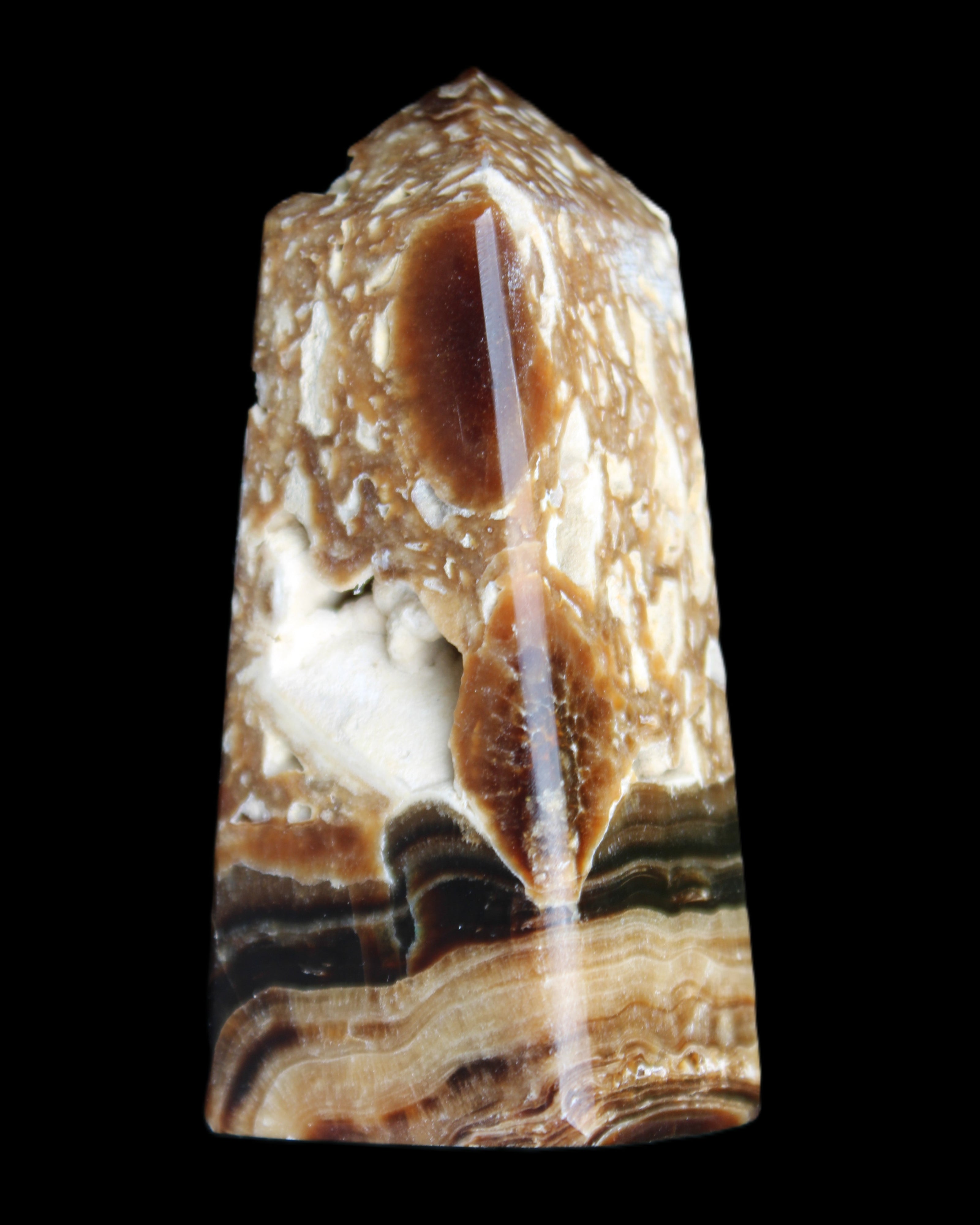 Chocolate Calcite obelisk with caves 95*40mm 217g in UV light - Rocks and Things Store