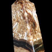 Chocolate Calcite obelisk with caves 95*40mm 217g in UV light - Rocks and Things Store