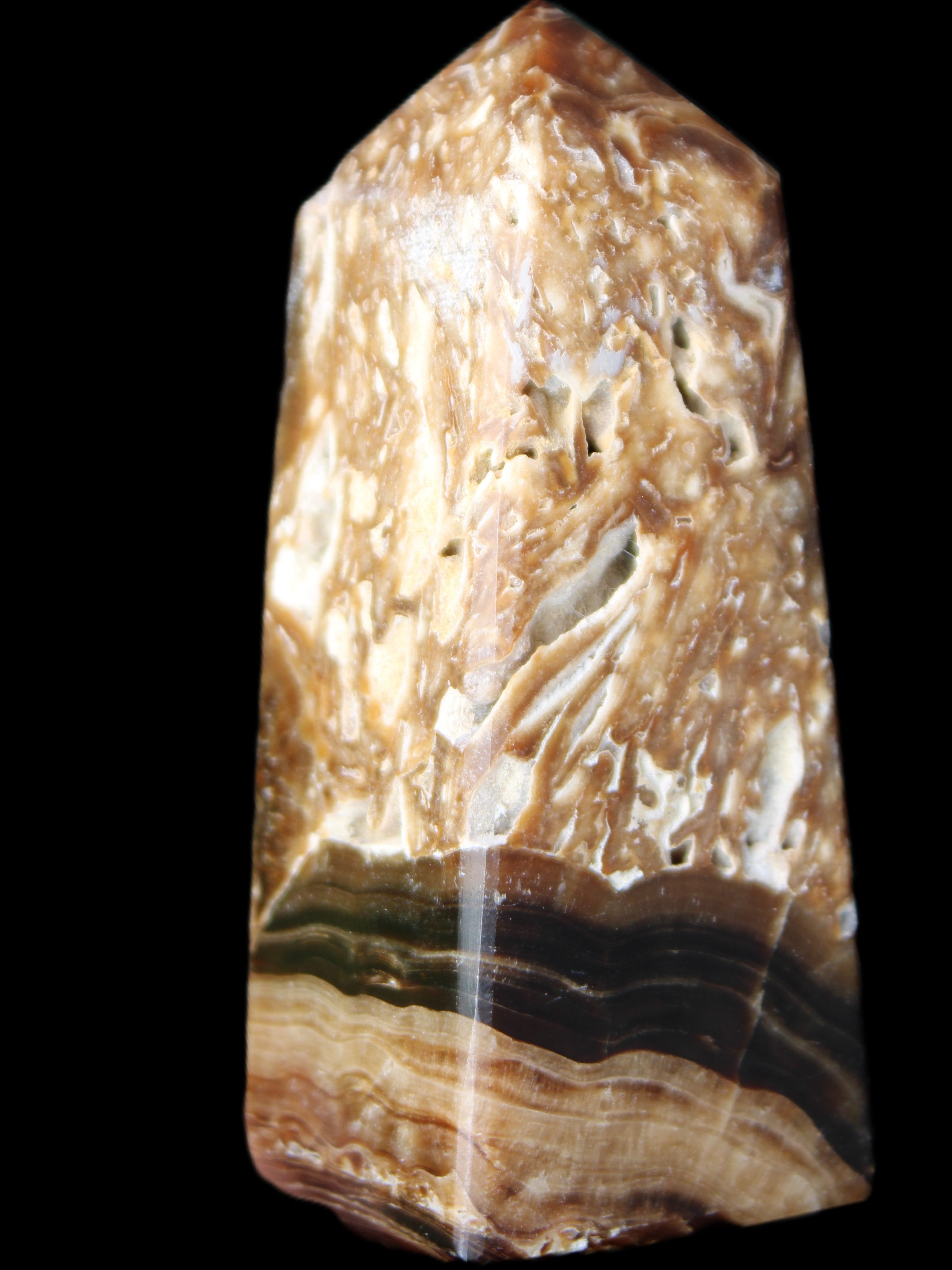 Chocolate Calcite obelisk with caves 95*40mm 217g in UV light - Rocks and Things Store