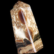 Chocolate Calcite obelisk with caves 95*40mm 217g in UV light - Rocks and Things Store