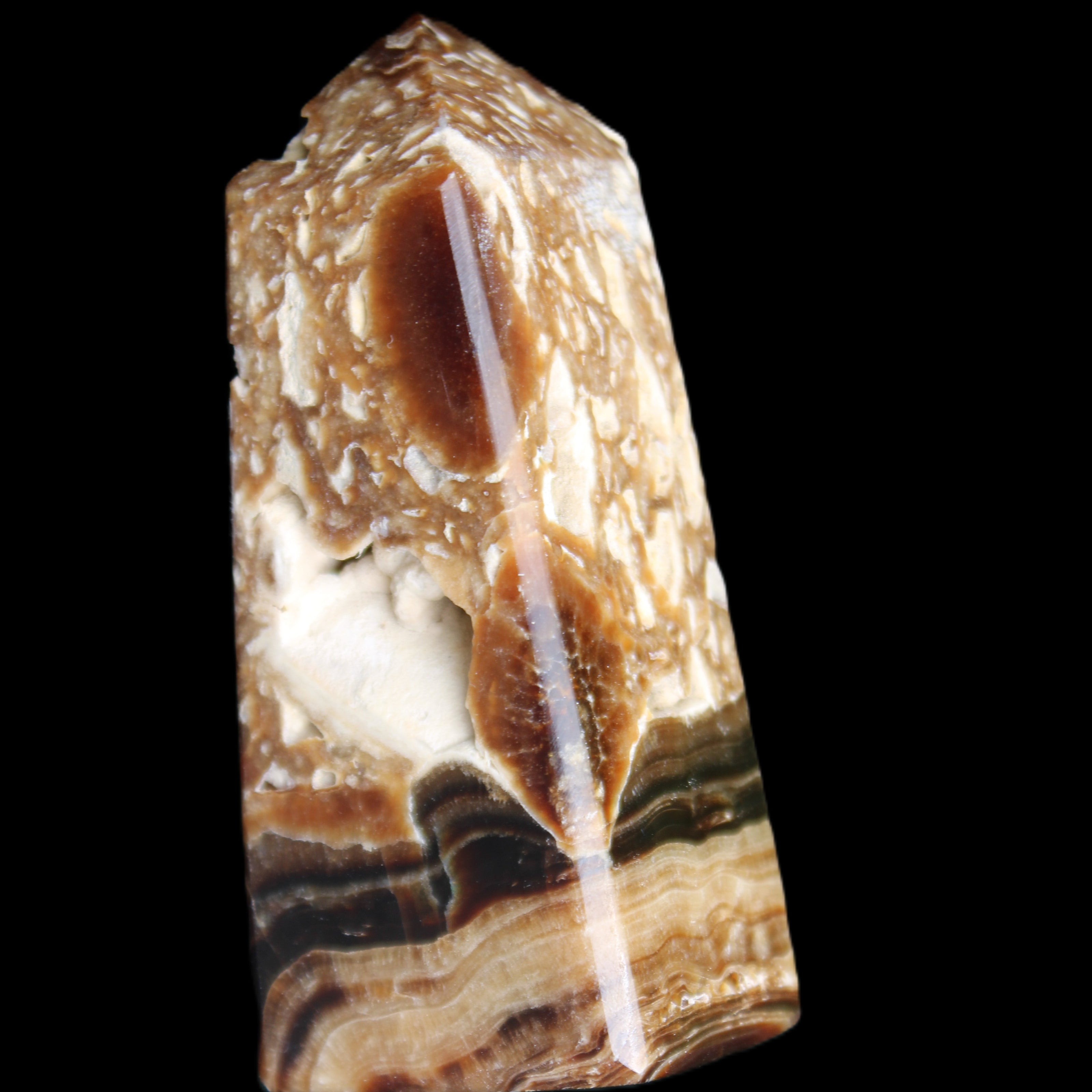 Chocolate Calcite obelisk with caves 95*40mm 217g in UV light - Rocks and Things Store