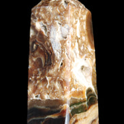 Chocolate Calcite obelisk with caves 95*40mm 217g in UV light - Rocks and Things Store