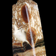 Chocolate Calcite obelisk with caves 95*40mm 217g in UV light - Rocks and Things Store