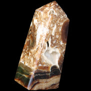 Chocolate Calcite obelisk with caves 95*40mm 217g in UV light - Rocks and Things Store