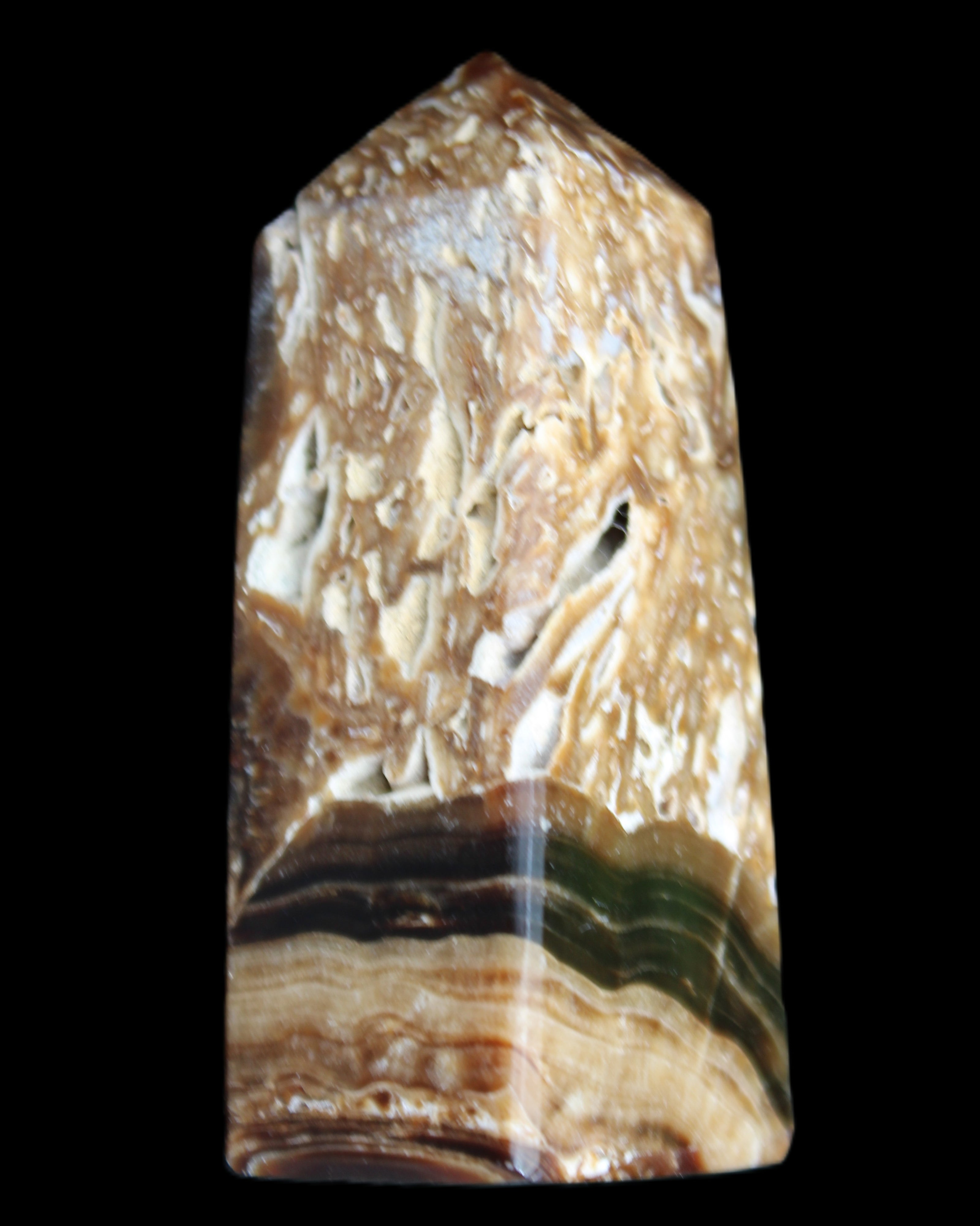 Chocolate Calcite obelisk with caves 95*40mm 217g in UV light - Rocks and Things Store