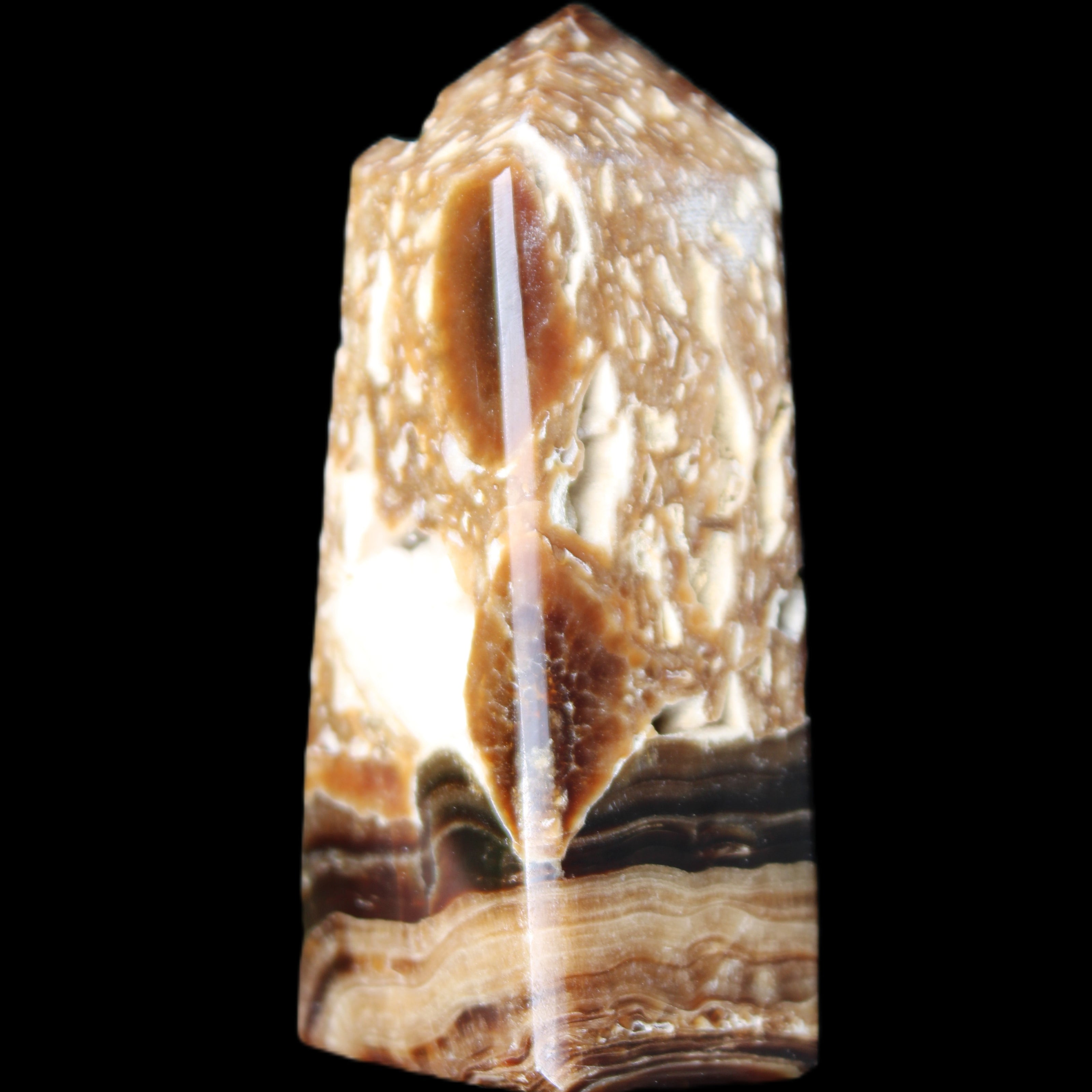 Chocolate Calcite obelisk with caves 95*40mm 217g in UV light - Rocks and Things Store