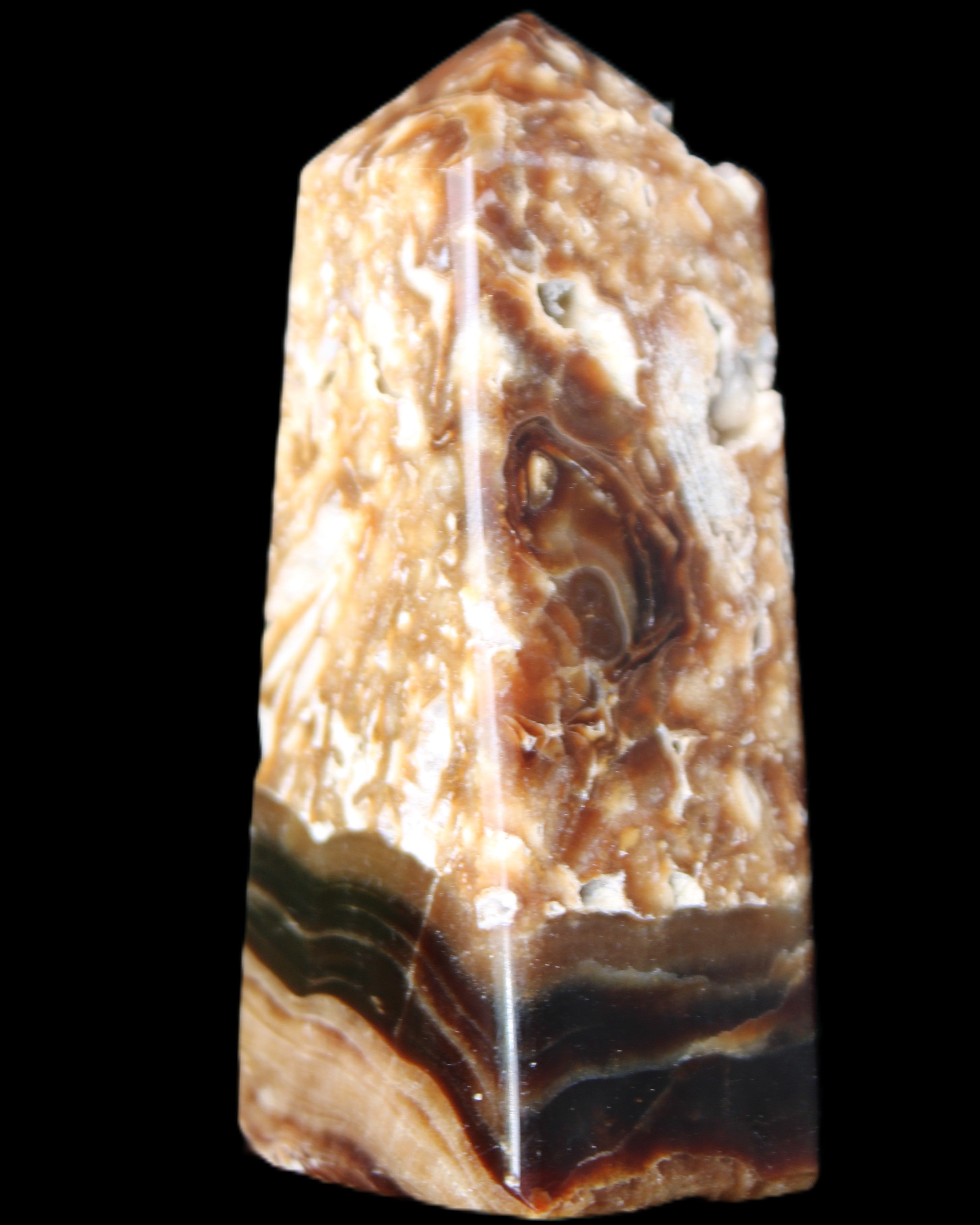 Chocolate Calcite obelisk with caves 95*40mm 217g in UV light - Rocks and Things Store