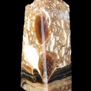 Chocolate Calcite obelisk with caves 95*40mm 217g in UV light - Rocks and Things Store