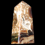 Chocolate Calcite obelisk with caves 95*40mm 217g in UV light - Rocks and Things Store