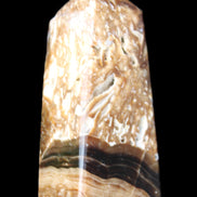 Chocolate Calcite obelisk with caves 95*40mm 217g in UV light - Rocks and Things Store