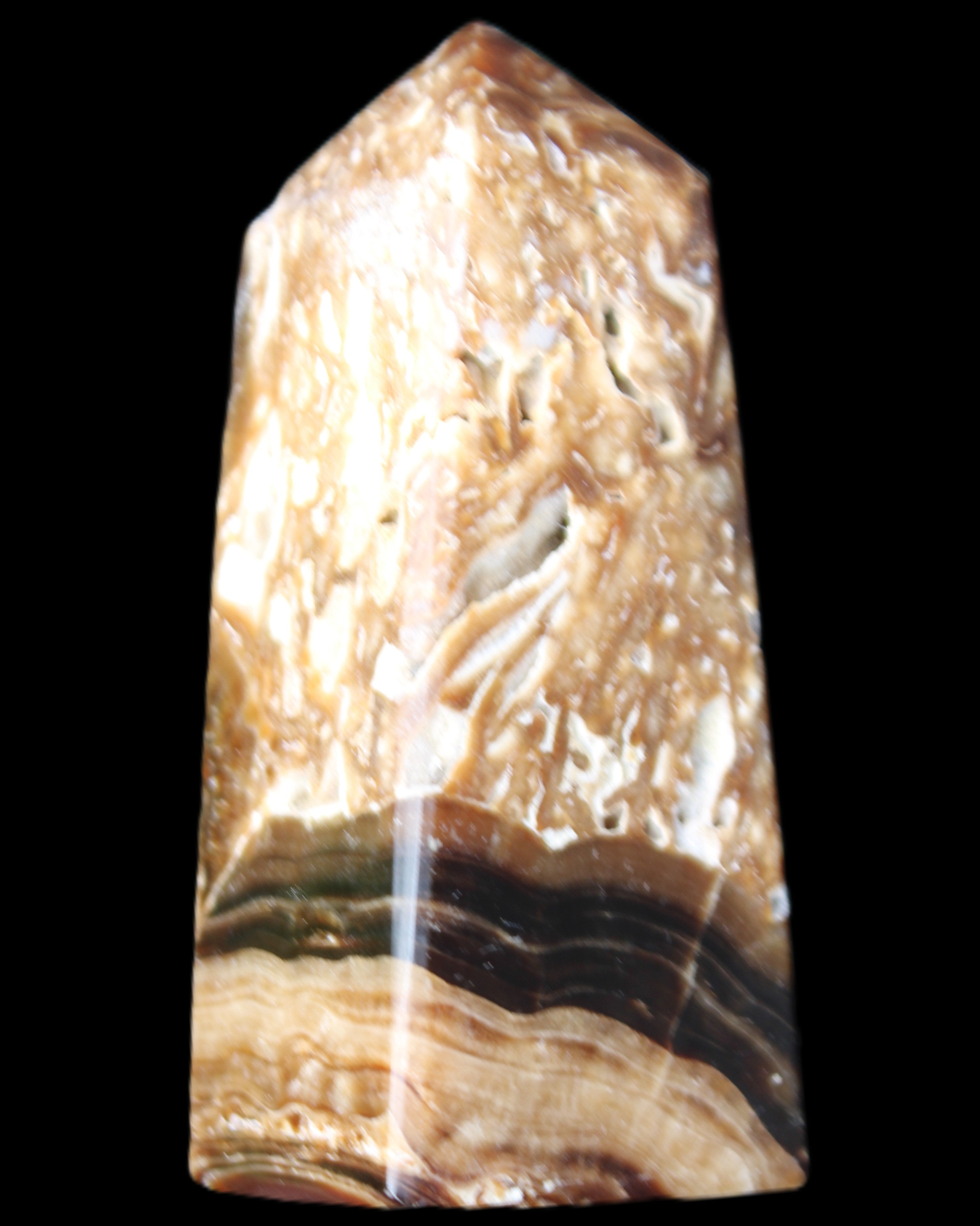 Chocolate Calcite obelisk with caves 95*40mm 217g in UV light - Rocks and Things Store