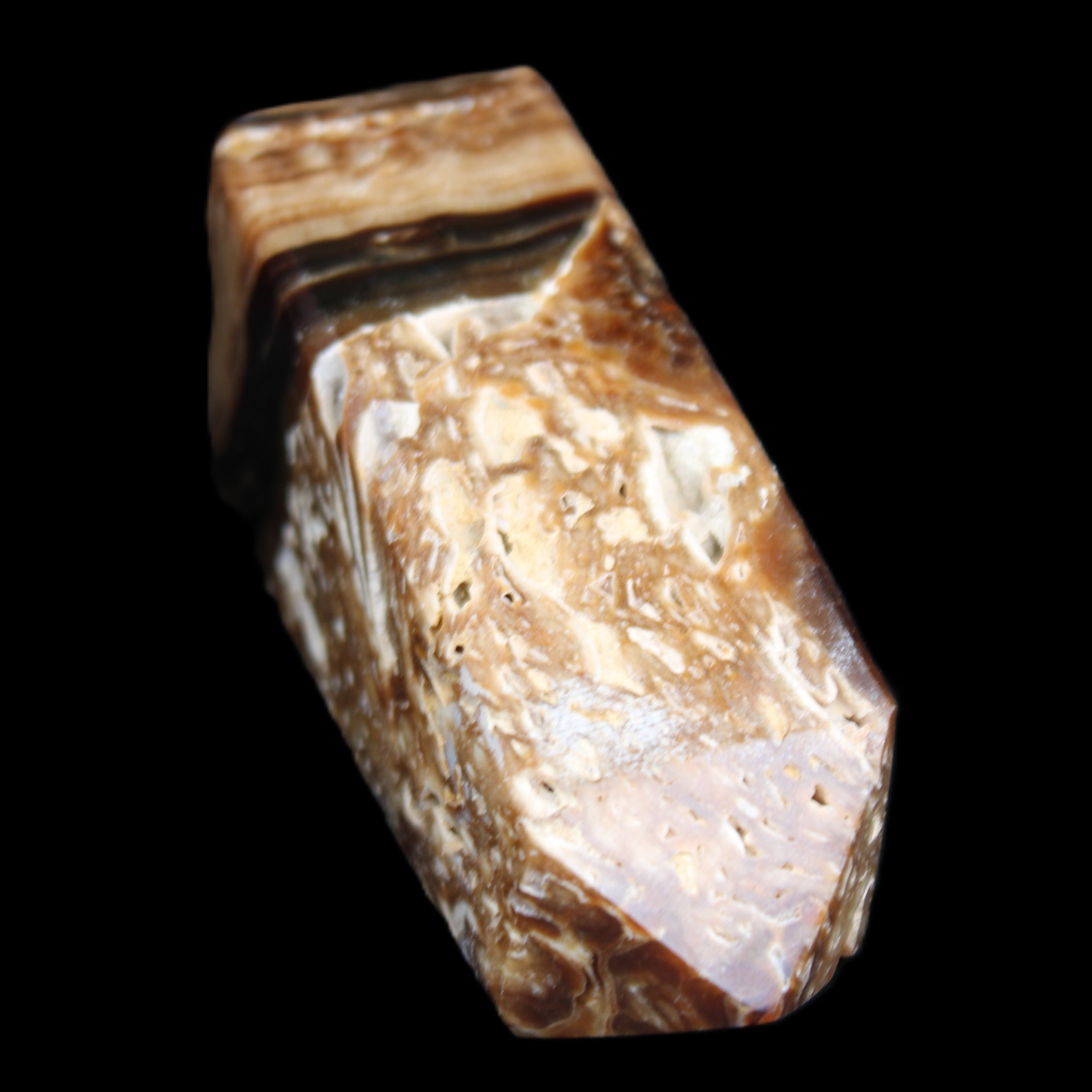 Chocolate Calcite obelisk with caves 95*40mm 217g in UV light - Rocks and Things Store