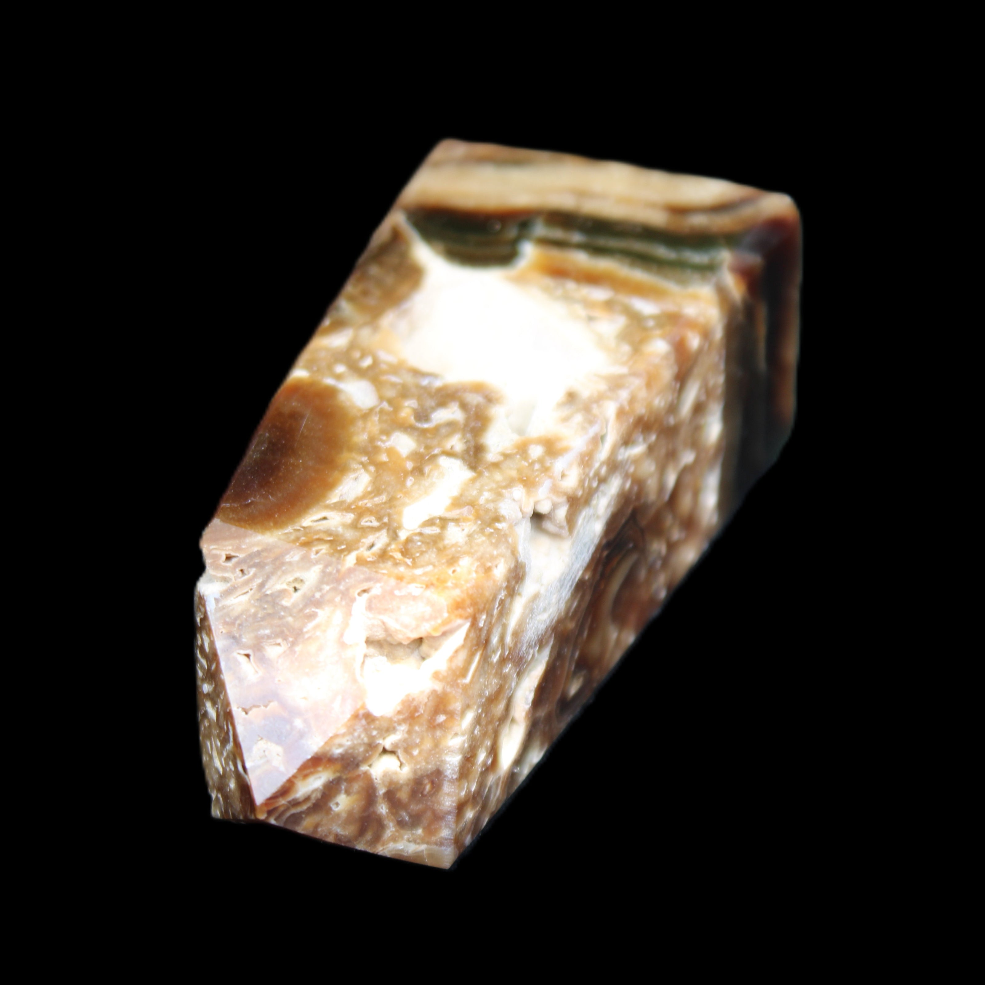 Chocolate Calcite obelisk with caves 95*40mm 217g in UV light - Rocks and Things Store