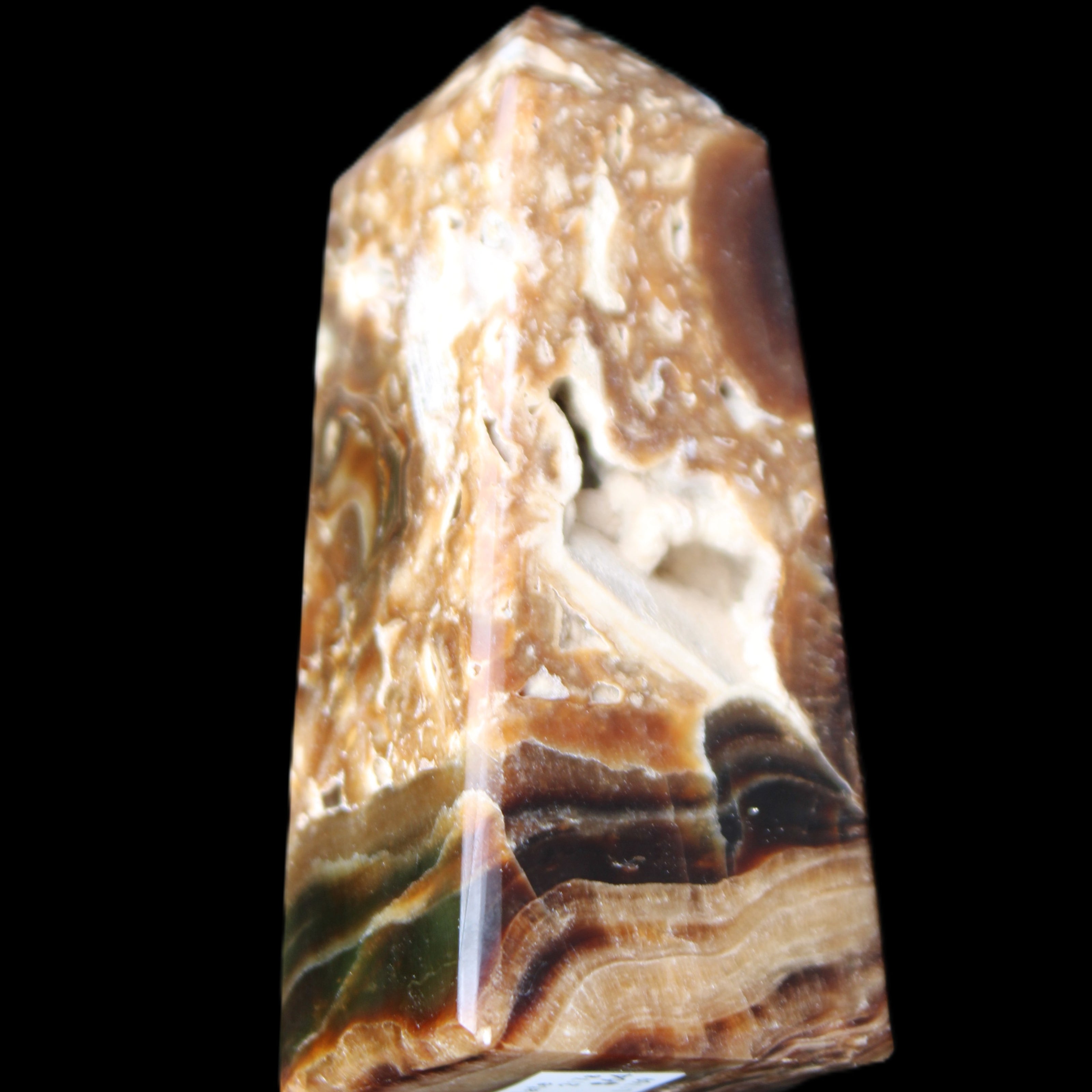 Chocolate Calcite obelisk with caves 95*40mm 217g in UV light - Rocks and Things Store