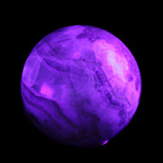 Orange, Lime & Lemon Aragonite sphere 648g in UV light - Rocks and Things Store