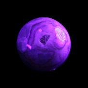 Orange, Lime & Lemon Aragonite sphere 648g in UV light - Rocks and Things Store