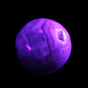 Orange, Lime & Lemon Aragonite sphere 648g in UV light - Rocks and Things Store