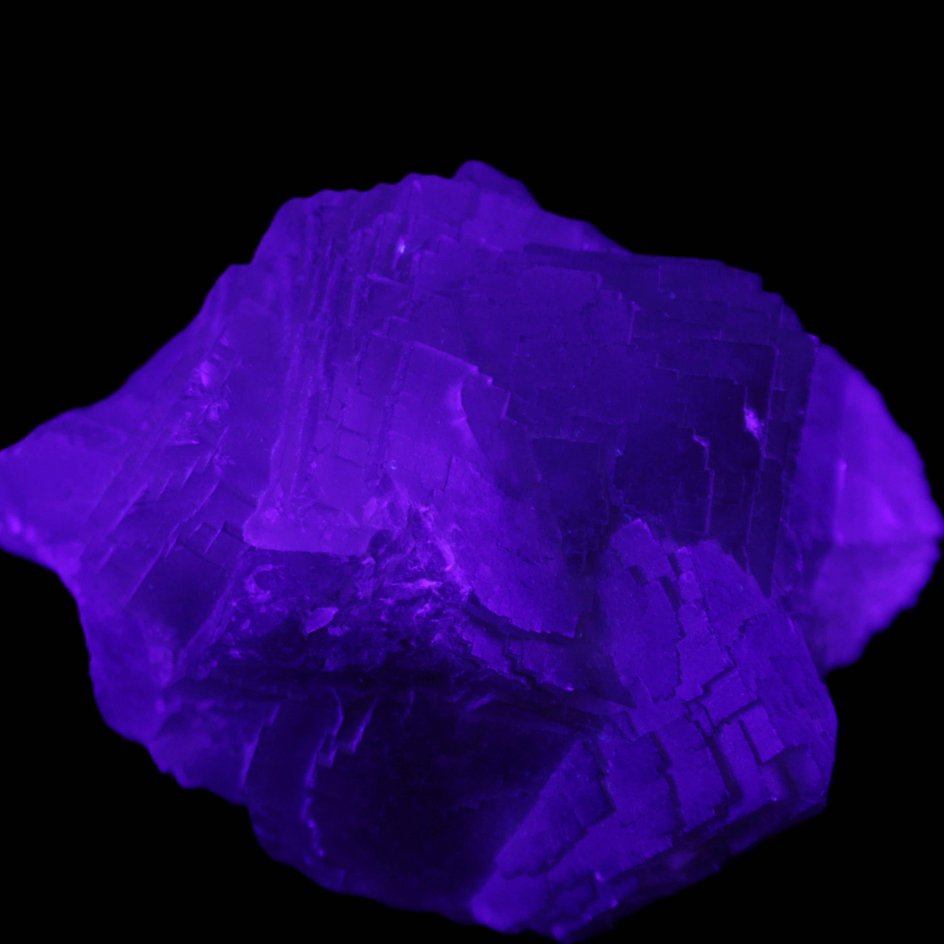 Clear Fluorite cubic cluster 82*58*60mm 404g in UV light - Rocks and Things Store