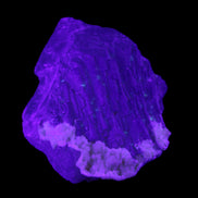 Clear with Violet tinged Fluorite cubic cluster 75*72*55mm 386g in UV light - Rocks and Things Store