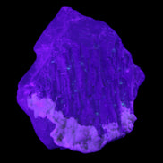 Clear with Violet tinged Fluorite cubic cluster 75*72*55mm 386g in UV light - Rocks and Things Store
