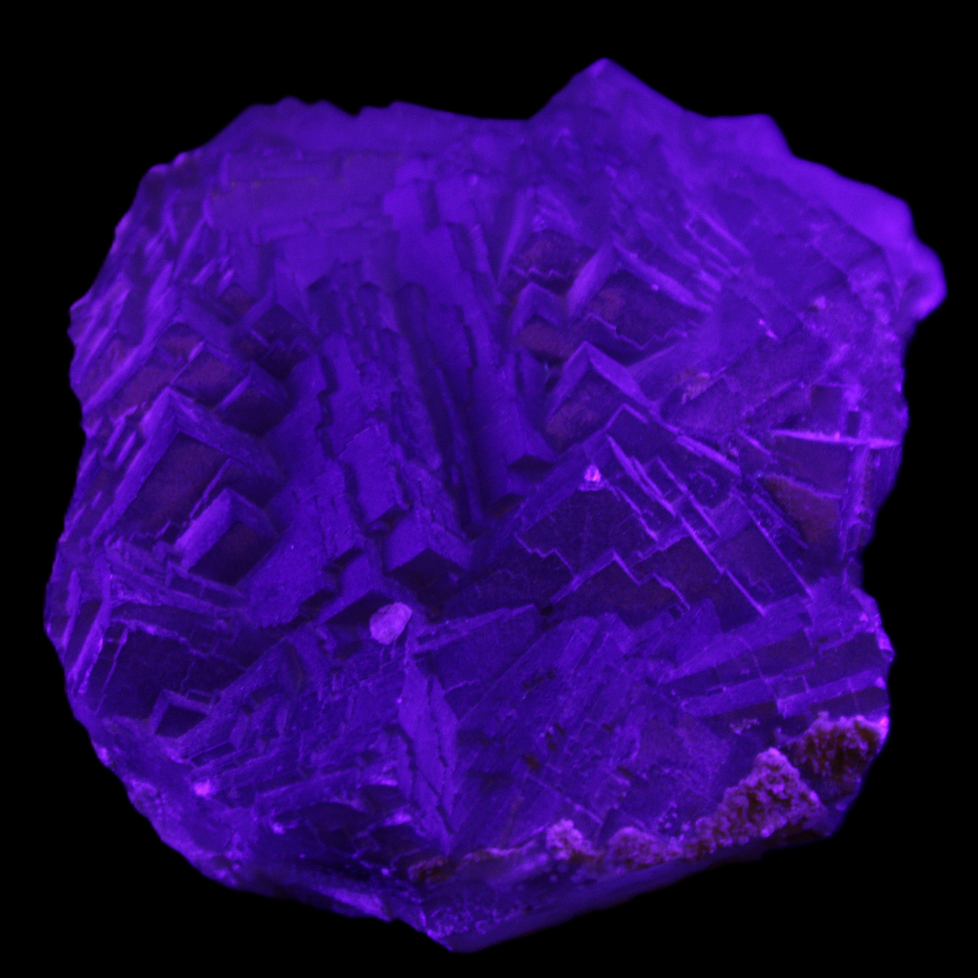 Clear Fluorite cubic stepped cluster 104*72*50mm 660g in UV light - Rocks and Things Store