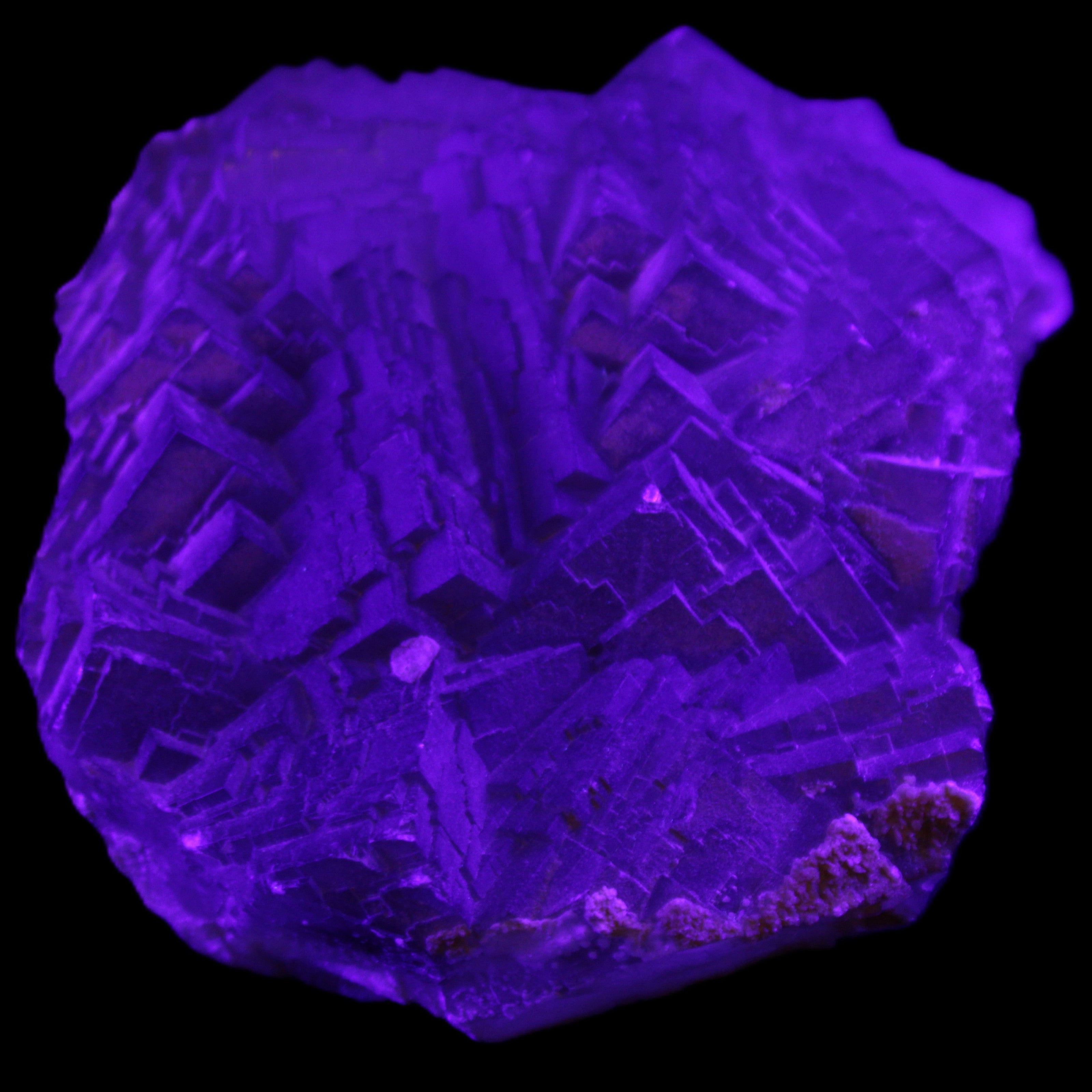 Clear Fluorite cubic stepped cluster 104*72*50mm 660g in UV light - Rocks and Things Store