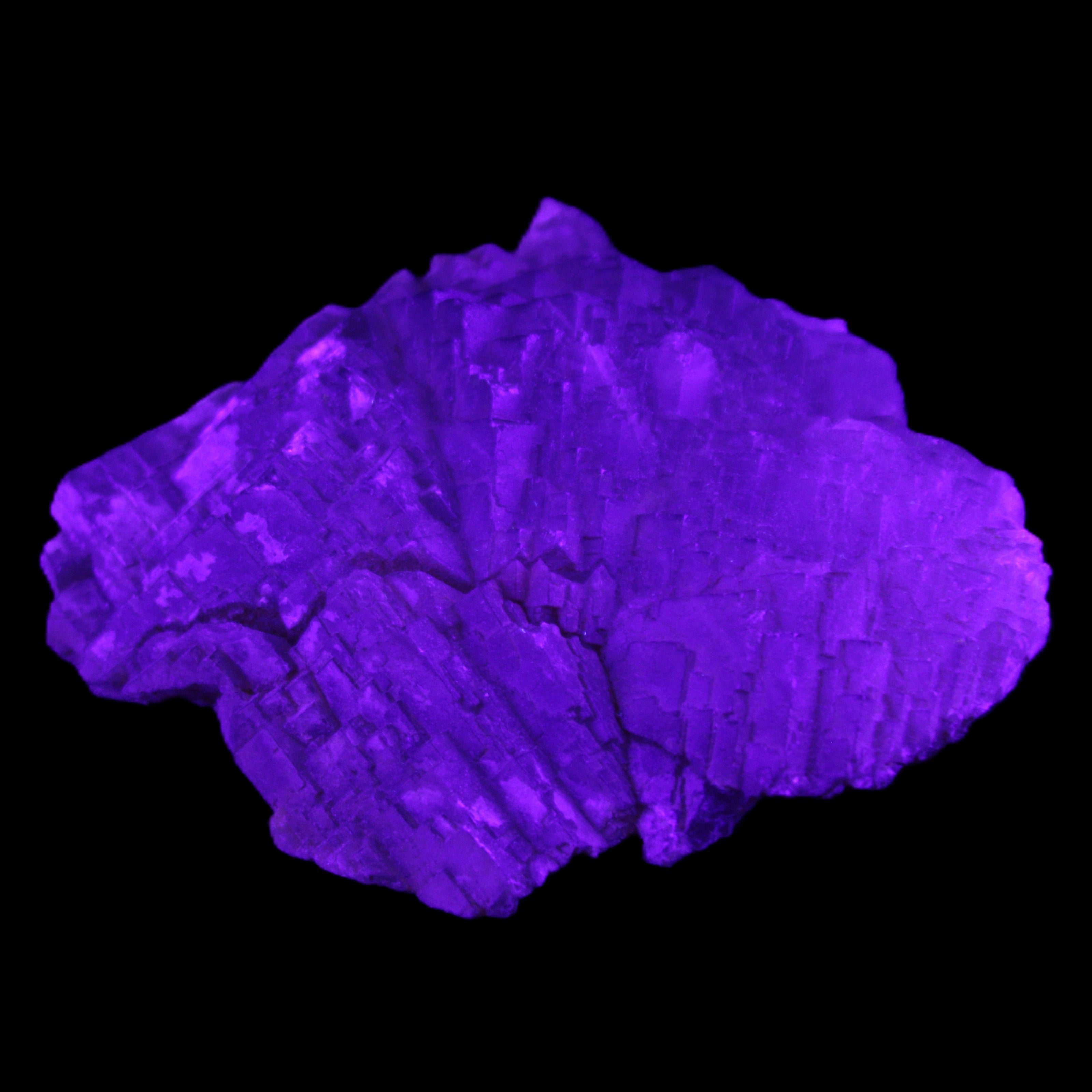 Clear Fluorite stepped cluster 87*80*28mm 238g in UV light - Rocks and Things Store