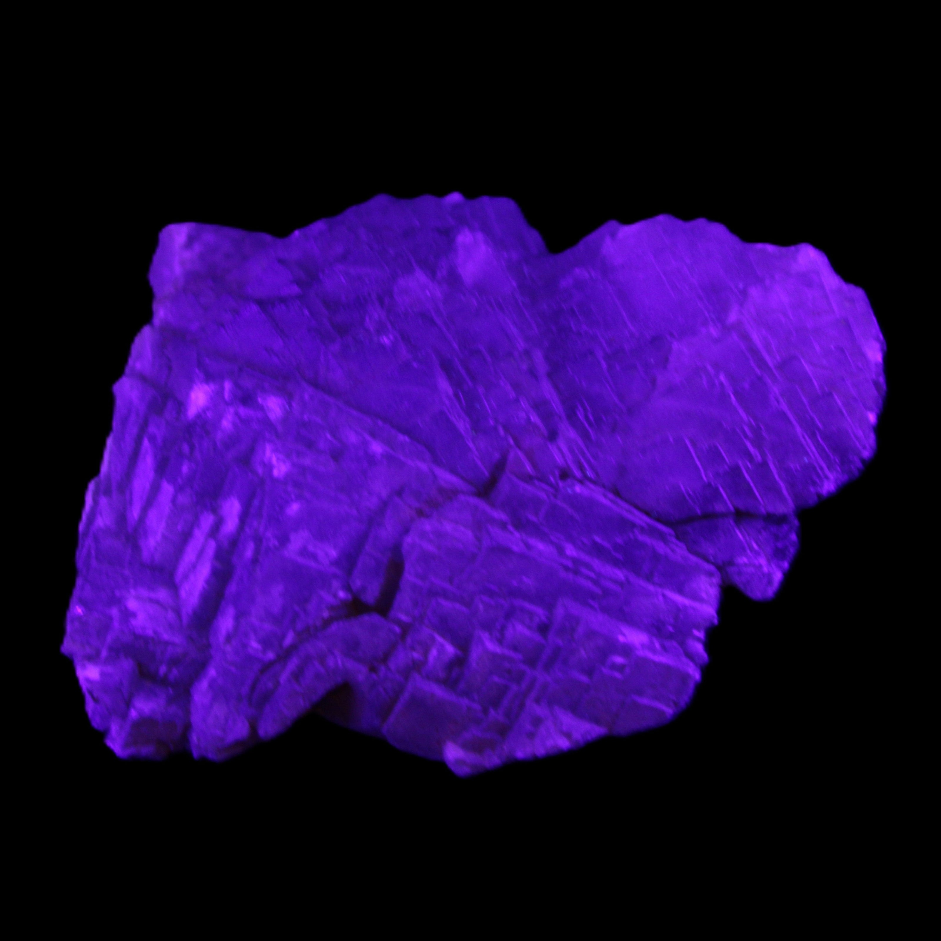 Clear Fluorite stepped cluster 87*80*28mm 238g in UV light - Rocks and Things Store